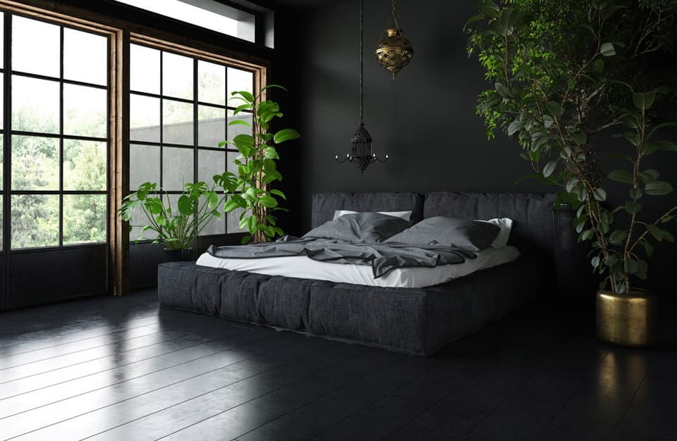 czarne łóżko podłoga ściana i okna zielone drzewka