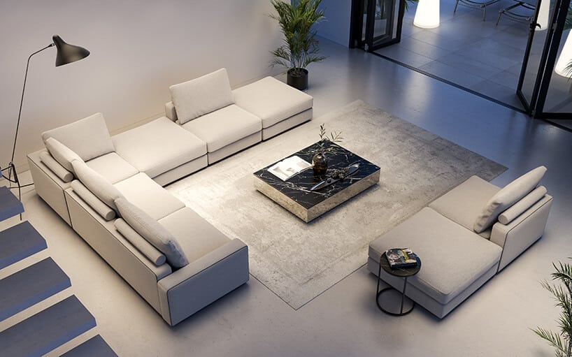 nowoczesne wnętrze z kamienną jasną podłogą z modułowa narożną sofą przy czarnym kamiennym stoliku na szarym dywanie