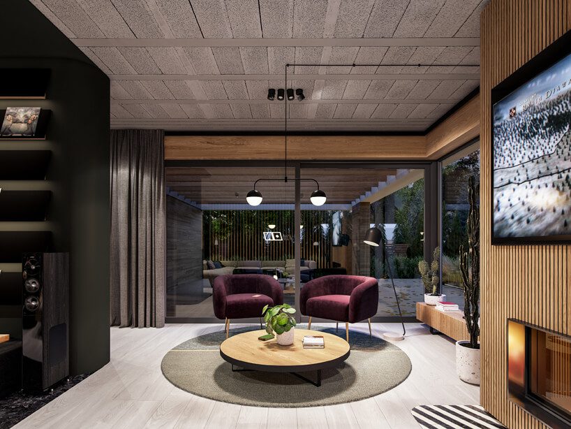 projekt nowoczesnego wnętrza domu od Zarysy dwa bordowe fotele przy niskim okrągłym stoliku na szarym okrągłym dywanie