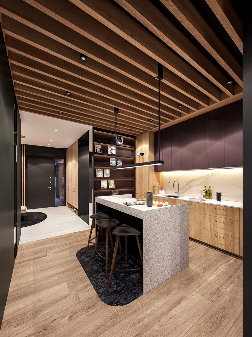 projekt nowoczesnego wnętrza domu od Zarysy drewniana kuchnia z małą wyspą wykończoną jasnym kamieniem na drewnianej podłodze