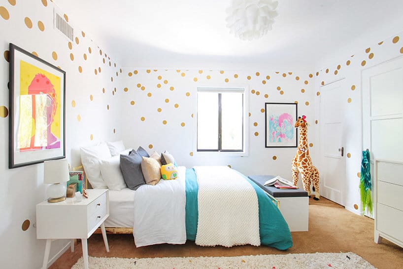 pokój dziecka z dużym łóżkiem i żyrafą w koncie